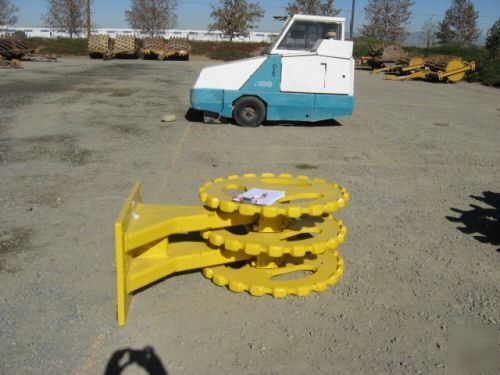 Yellow 22 inch compactor wheel trenchmaster backhoe